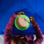 Child receiving StartWell nutrient-dense breakfast to support healthy development