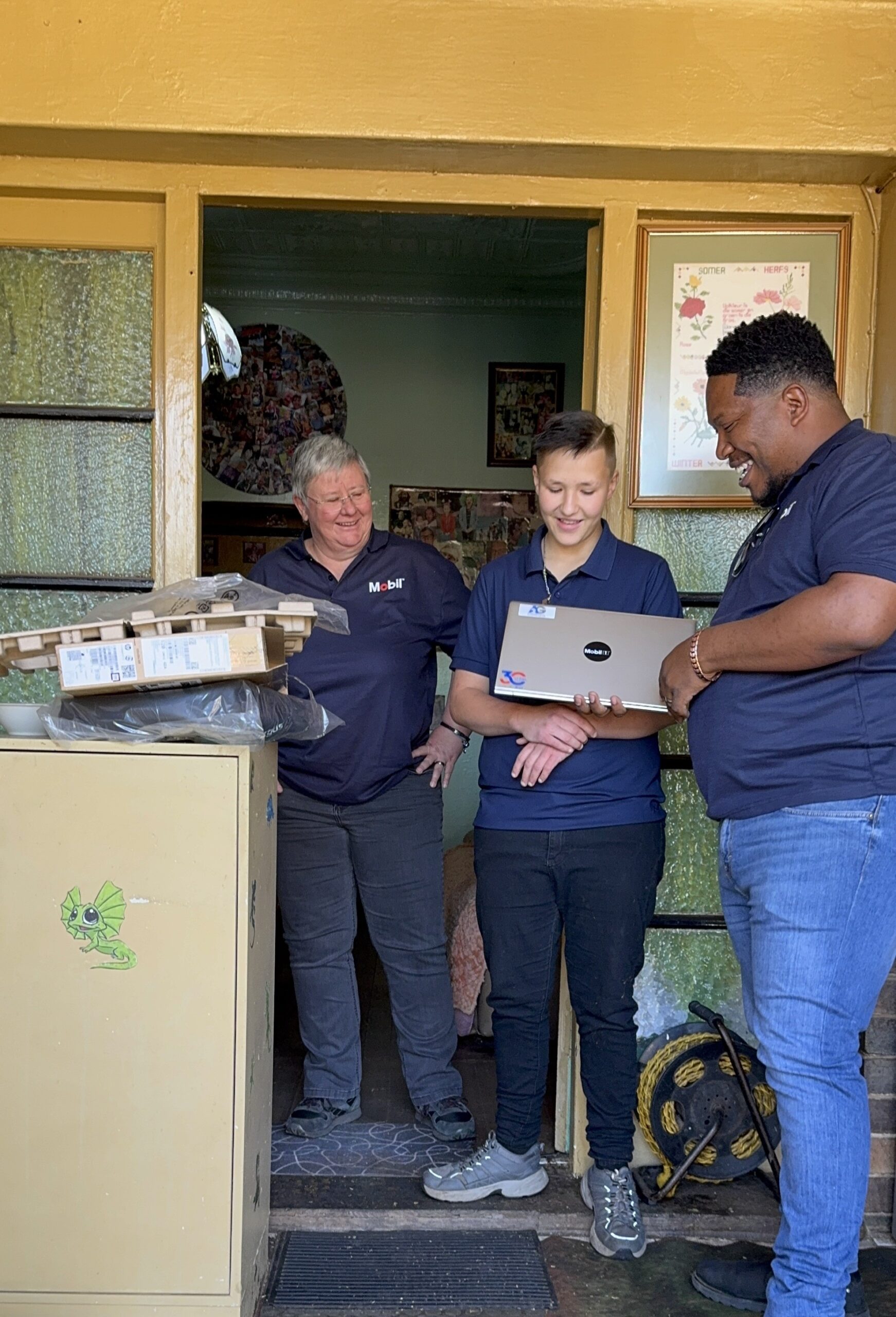 Kagiso-Donga-of-AG-Lubricants-hands-over-a-laptop-to-support-a-learners-education-1